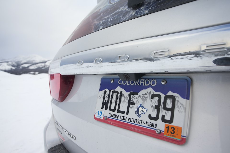 Car with number plate indicating support for wolves in Yellowstone National Park, USA