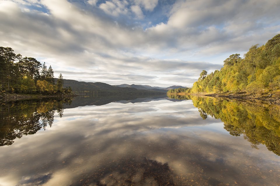 Autumn reflections over Loch Beinn a Mheadhain, Glen Affric, Scotland.